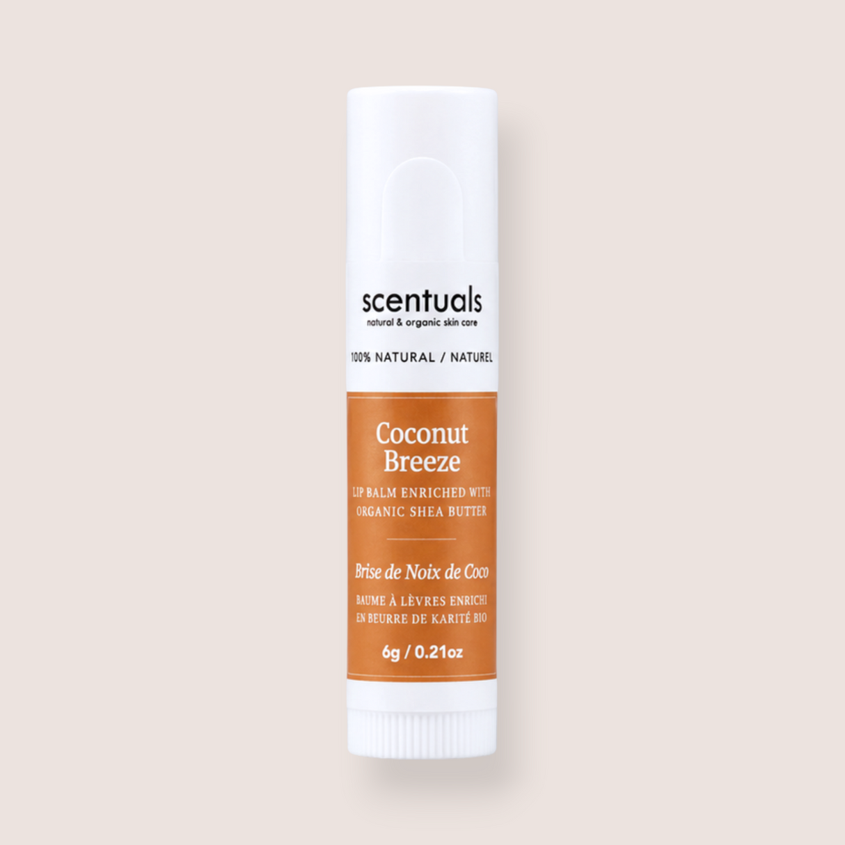 A single tube of Scentuals Coconut Breeze lip balm on a solid light beige background. The tube is white with a prominent orange-brown label and black text.