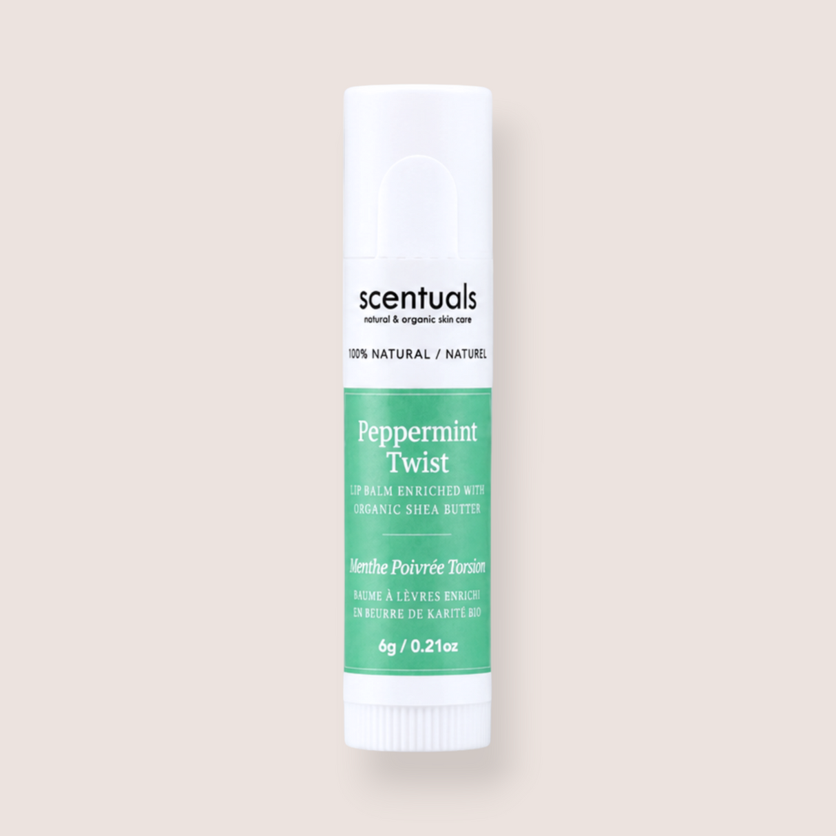 A tube of Scentuals Peppermint Twist lip balm, featuring a white container with a green label, centered on a solid pale beige background.