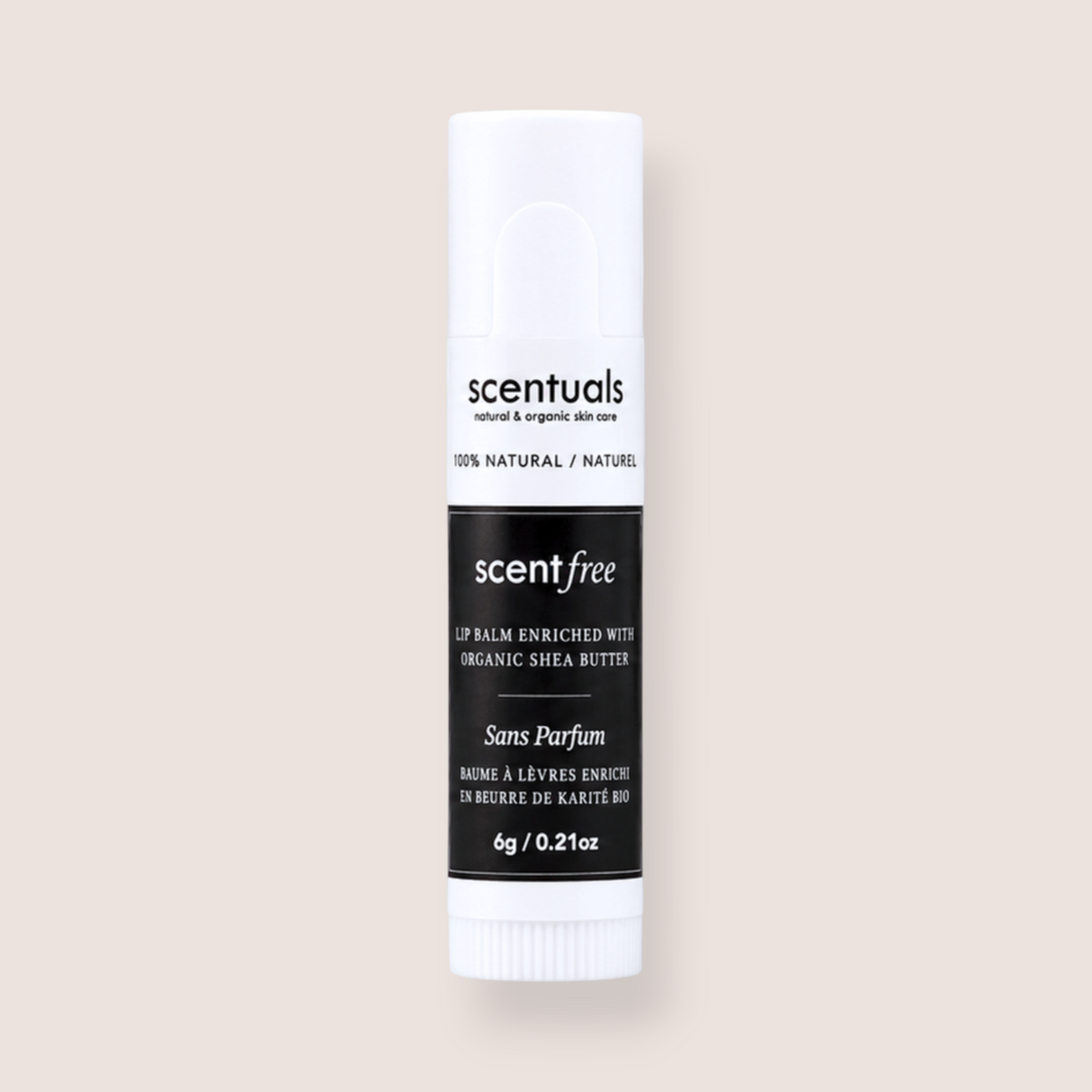 A single tube of Scentuals Scent Free lip balm with organic shea butter, shown against a solid, warm off-white background.