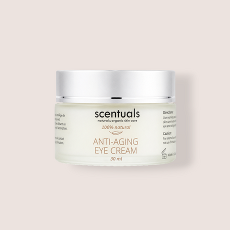 A jar of Scentuals Anti-Aging Eye Cream on a solid pale beige background.
