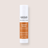 A single tube of Scentuals Coconut Breeze lip balm on a solid light beige background. The tube is white with a prominent orange-brown label and black text.