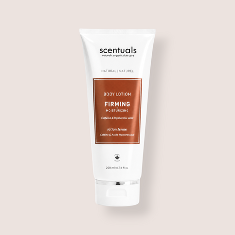 A white squeeze tube of Scentuals Firming Moisturizing Body Lotion with a metallic copper-brown label, centered on a light beige background.