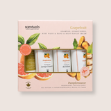 Scentuals Grapefruit & Pampomousse gift set containing a shampoo, conditioner, body wash, and hand & body repair cream in a light pink box with citrus illustrations.