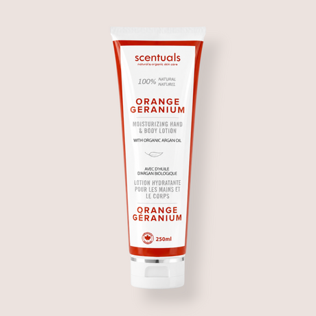 A 250ml squeeze tube of scentuals Orange Geranium Moisturizing Hand & Body Lotion, featuring a white tube with bold red and black text, set against a solid light beige background.