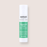 A tube of Scentuals Peppermint Twist lip balm, featuring a white container with a green label, centered on a solid pale beige background.