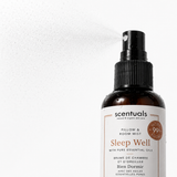 A bottle of Scentuals Sleep Well Pillow & Room Mist with a black spray nozzle and white label, shown with mist spraying from the top against a white background.