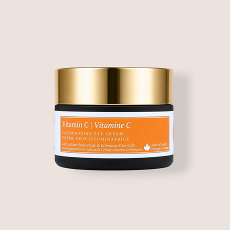 A small cosmetic jar of Vitamin C Brightening Gel Cream with a shiny gold lid, black base, and an orange and white label, centered on a light beige background.